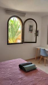 a bedroom with a bed and a large mirror at Casa Mona in Corralejo