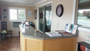 a kitchen with a counter with a clock on the wall at Blue Pine Motel in Panguitch