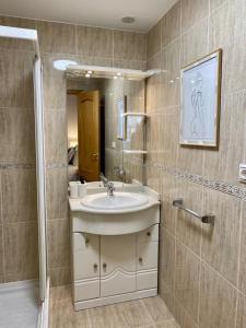 a bathroom with a sink and a mirror at Andainas G in Milladoiro