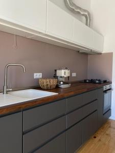 a kitchen with a sink and a counter top at Casa Figo - Aljezur old town in Aljezur