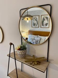 a round mirror on a shelf in a bedroom at Andainas G in Milladoiro