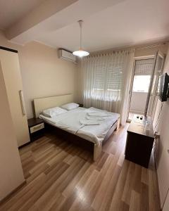 a small bedroom with a bed and a window at Motel Centar in Bijeljina
