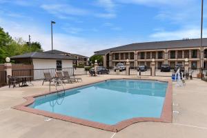 a large swimming pool in front of a building at Mockingbird Inn & Suites in Monroeville
