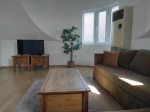 a living room with a couch and a coffee table at Varna Seaview Apartment in Varna City