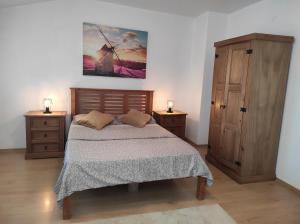 a bedroom with a bed and a dresser with two lamps at Varna Seaview Apartment in Varna City