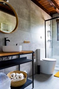 a bathroom with a sink and a toilet and a mirror at El Mirador de las Cuencas in Abiada