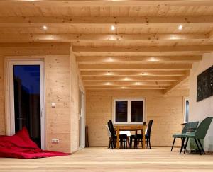 a wooden house with a table and chairs on a deck at Ferienhaus Bergstätter Sonne in Immenstadt im Allgäu