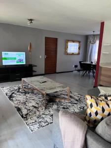 a living room with a couch and a table at Iyana Place in Midrand