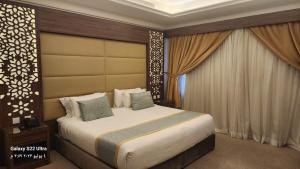 a bedroom with a large bed in a room at Moon View Hotel in Jeddah