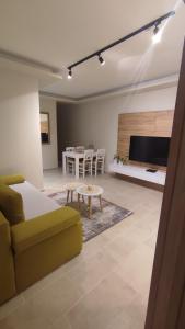 a living room with a couch and a table at Apartman Front in Šid