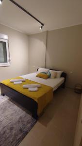 a bedroom with a large bed with towels on it at Apartman Front in Šid
