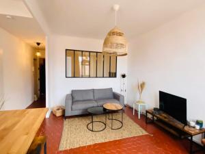 a living room with a couch and a tv at Le repère des pêcheurs in Marseille