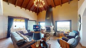 a living room with a couch and a fireplace at Luxury Colonial Country Villa in Moya