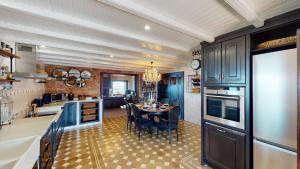 a kitchen with blue cabinets and a table with chairs at Luxury Colonial Country Villa in Moya