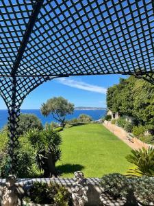 a view of a garden with a view of the ocean at Completely renovated villa in Cap d'Ail