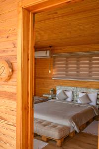 a bedroom with a bed in a wooden cabin at Le Parc des Oliviers in Marrakech