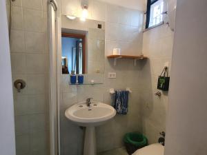 a bathroom with a sink and a toilet at La capannina cilento cam 10 in San Marco di Castellabate +31 photos