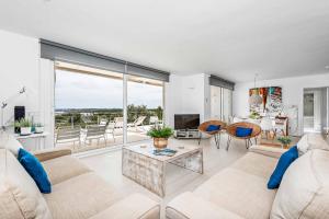 a living room with a couch and a table at Villa Sarah in Es Mercadal