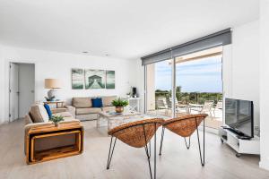 a living room with a couch and a tv at Villa Sarah in Es Mercadal
