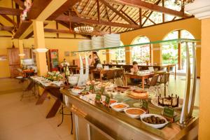 a buffet in a restaurant with a lot of food at Haras Morena Resort in Juiz de Fora