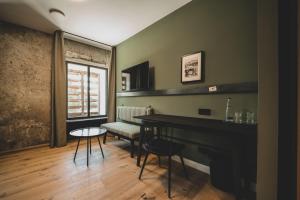 a living room with a piano and a table at LANDHOTEL ALTE ZOLLSTATION- Historical Building in Pittenhart