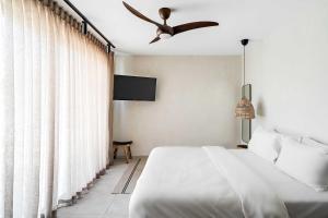 a bedroom with a bed and a ceiling fan at Hotel Anilevich Mansion in Beer Sheva