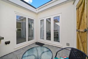 a patio with french doors and a table and chairs at Bristol Short Stays Brislington Sleeps 4-9 Free Parking in Bristol