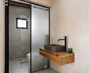 a bathroom with a sink and a shower at Hotel Anilevich Mansion in Beer Sheva