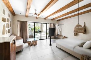 a living room with a couch and a tv at Hotel Anilevich Mansion in Beer Sheva