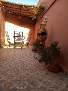 a room with a patio with chairs and a table at Logement entier riad Dar Sana in Marrakesh