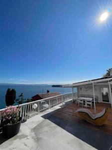a house with a deck with a view of the ocean at Sunrise SeaView Apartment Fiesa in Piran
