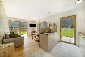 a kitchen and living room with a couch and a table at Masi Rosmarin in Santa Valpurga