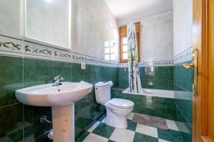 a bathroom with a white toilet and a sink at Vila Tres Cales in Les tres Cales +30 photos