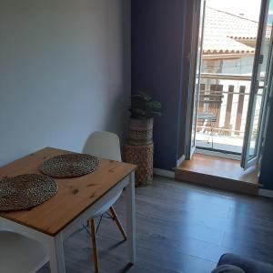 a dining room with a table and chairs and a window at Casa de Bairros in Soajo