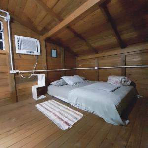 Tempat tidur dalam kamar di Tiny House moçambique - Sua casinha em Floripa!