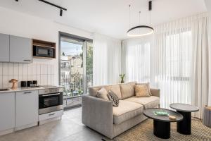a living room with a couch and a table at Mate GEORGE with MAMAD - By HOMY in Tel Aviv