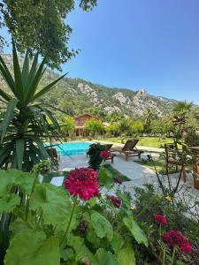 a garden with flowers and a swimming pool at Sedir Palas in Cıralı