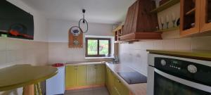 a small kitchen with a stove and a window at Apartma Aria&Karra in Komen