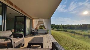 a porch of a house with a view of a field at Klangor Mechowo in Mechowo