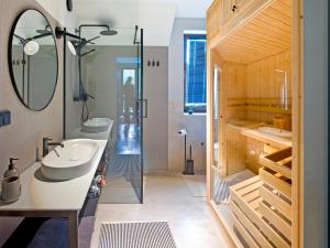 a bathroom with two sinks and a mirror at Apartamenty Łasica Jaworki in Jaworki