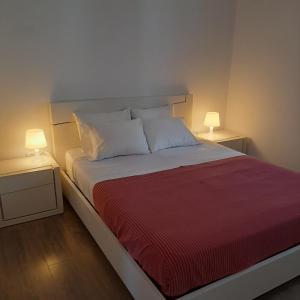 a bedroom with a large bed with two night stands at Casa de Bairros in Soajo