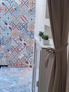 a kitchen with a tile floor and a refrigerator at Suite Duomo Trani 6 in Trani