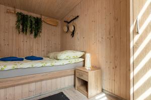 a room with a bed in a wooden cabin at Domki EVITA in Władysławowo