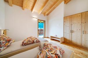 a bedroom with two beds and a window at Masi Lavendel in Santa Valburga St. Walburg +9 photos