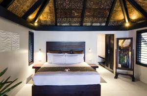 a bedroom with a large bed in a room at Matamanoa Island Resort in Matamanoa Island