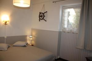 a small bedroom with a bed and a window at A CARDICCIA Loc saisonnières PIANA in Piana