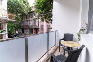 a balcony with two chairs and a table on it at City center 2-Bedroom Apartment in Plovdiv
