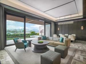 a living room with a couch and chairs and a table at Sheraton Ninghai in Ninghai