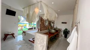 a bathroom with a tub and a sink in a room at Sollaris Ecopousada in Japaratinga