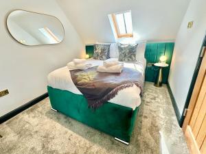 a bedroom with a bed with a large mirror at Black Swan Mews in Ripon